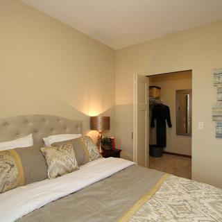A cozy and well-decorated bedroom with soft lighting and comfortable bedding.