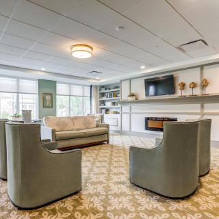 A modern living room with comfortable seating, a television, and a fireplace.