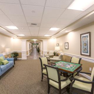 A cozy residential hallway featuring a game table and comfortable seating.