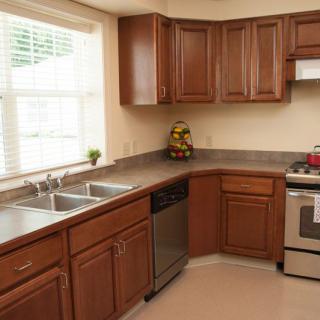 A modern kitchen with wooden cabinets and stainless steel appliances.