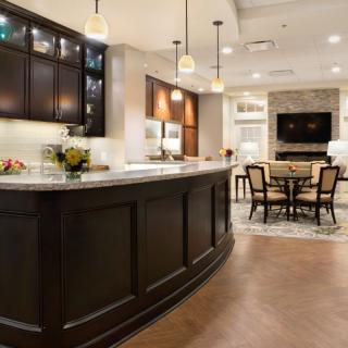 A modern kitchen with a large island and an open concept dining area.