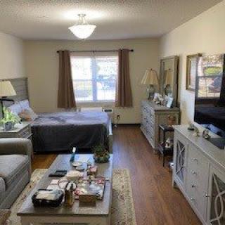 A cozy studio apartment with a combined living and sleeping area.