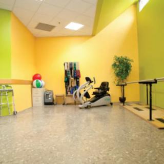 A physical therapy room equipped with exercise machines and rehabilitation tools.