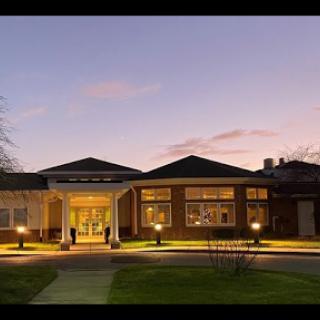 A beautifully-lit building entrance at sunset, showcasing modern architecture.