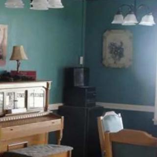 A cozy room with a piano and soft lighting.