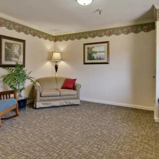 A cozy living room with a sofa, armchair, and decorative elements.