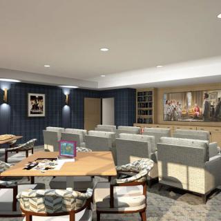 A modern living room with comfortable seating and artwork on the walls.