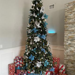 A beautifully decorated Christmas tree surrounded by colorful presents.