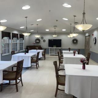 A spacious and well-lit dining area set up for an event.