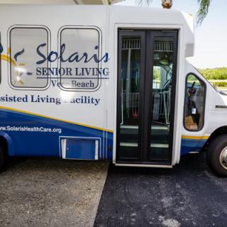 A transportation bus for Solaris Senior Living community, designed for accessibility.