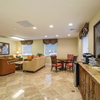 A spacious and elegantly designed living room with comfortable seating, a dining area, and tasteful decor.