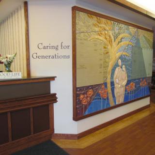 A welcoming reception area featuring a colorful mural with a caring theme.