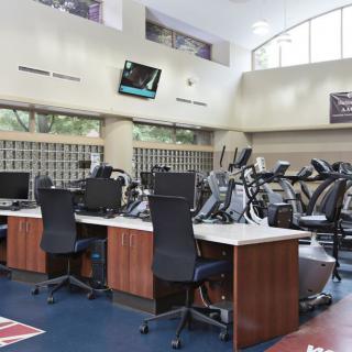A well-equipped fitness center with cardio machines and exercise equipment.