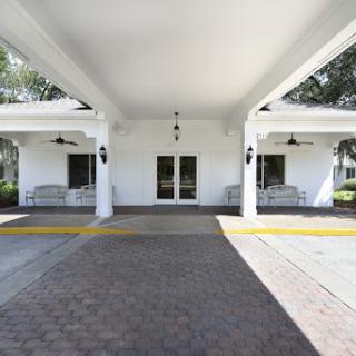 A welcoming entrance with a spacious porch and elegant architecture.