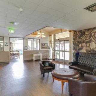 Spacious lobby area with comfortable seating and a rustic stone accent wall.