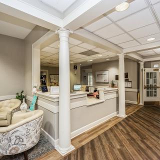 A modern reception area with a comfortable seating arrangement and a welcoming desk.