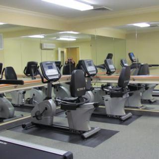 A fitness center with multiple stationary bikes lined up for exercise.