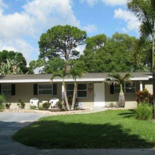 A single-story suburban house with a well-maintained garden and driveway.