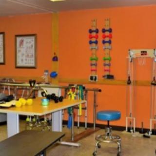 A physical therapy room equipped with various exercise and rehabilitation tools.