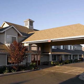 Exterior view of a hotel entrance with overhang.