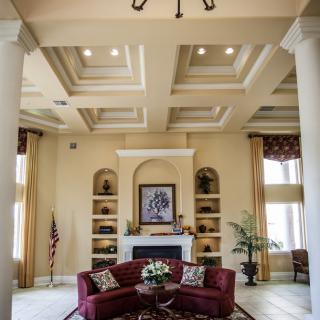 A luxurious living room with an elegant ceiling design and sophisticated furnishings.