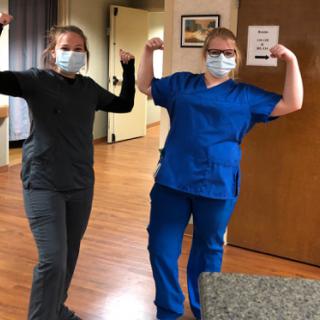 Healthcare workers showing their strength and teamwork while wearing masks.