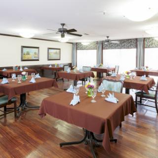 A cozy dining area set up with brown tablecloths, ready for guests.