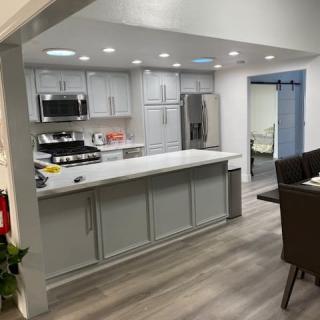 A modern kitchen with stainless steel appliances and sleek countertop.