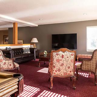 A cozy living room featuring a large TV, comfortable seating, and elegant decor.