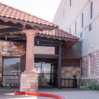Exterior view of a building entrance with an awning.