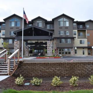 A modern hotel with a prominent entrance and landscaped surroundings.