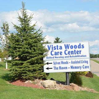 Vista Woods Care Center sign indicating directions for care services.