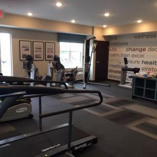 A modern gym with exercise equipment including treadmills and stationary bikes.