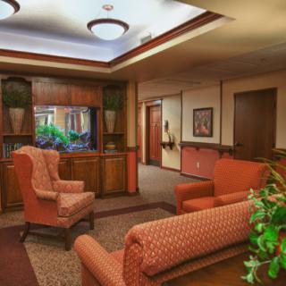 An elegant waiting room with comfortable seating and warm decor.
