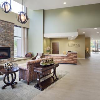 A modern lobby with comfortable seating and a fireplace.