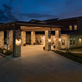 A modern building entrance illuminated at night.