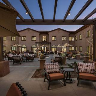 Elegant outdoor patio area with comfortable seating and ambient lighting at dusk.