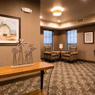 A cozy hotel lobby featuring comfortable seating, artwork, and stylish decor.