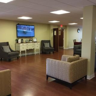 A comfortable lobby area with modern seating and a television.