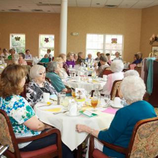 A group of seniors enjoying a community dining event.