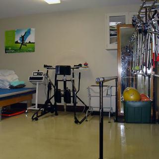 A well-equipped physical therapy room with various exercise equipment.