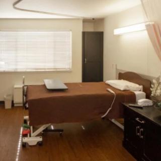 A hospital room with a bed and medical equipment.