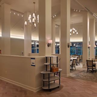 A modern and elegantly designed restaurant interior featuring stylish lighting and comfortable seating.