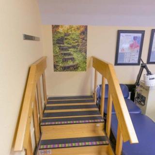 An office setting with a small staircase and wall decorations.