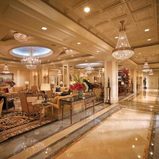 A luxurious hotel lobby with elegant chandeliers and sophisticated interior design.