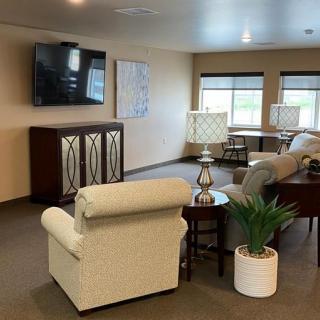 A cozy living room with a sofa, television, and decorative elements.