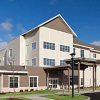 A modern residential building with a well-maintained exterior and clear blue sky.