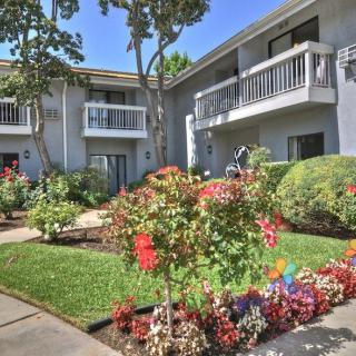 A well-maintained apartment building with a colorful garden.