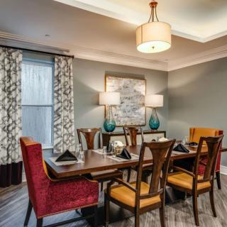A beautifully designed dining room with elegant furnishings and warm lighting.