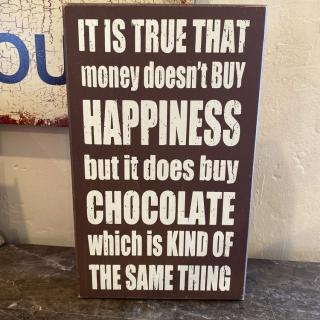 A humorous sign about money, happiness, and chocolate.